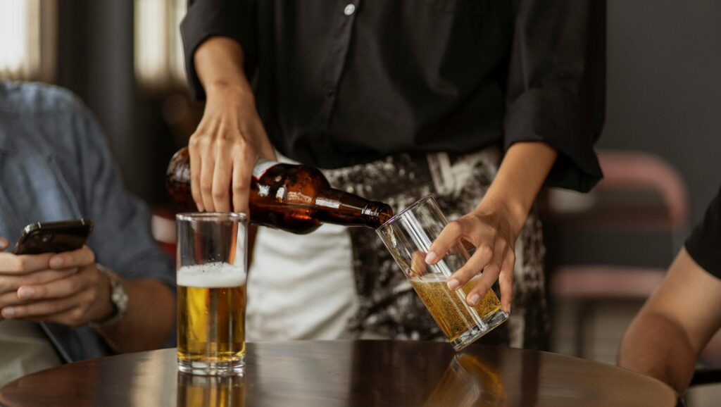 bartender pouring beer into a glass