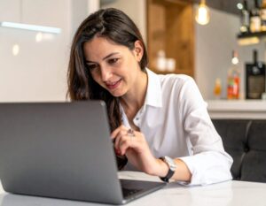 Woman using a laptop in her living room