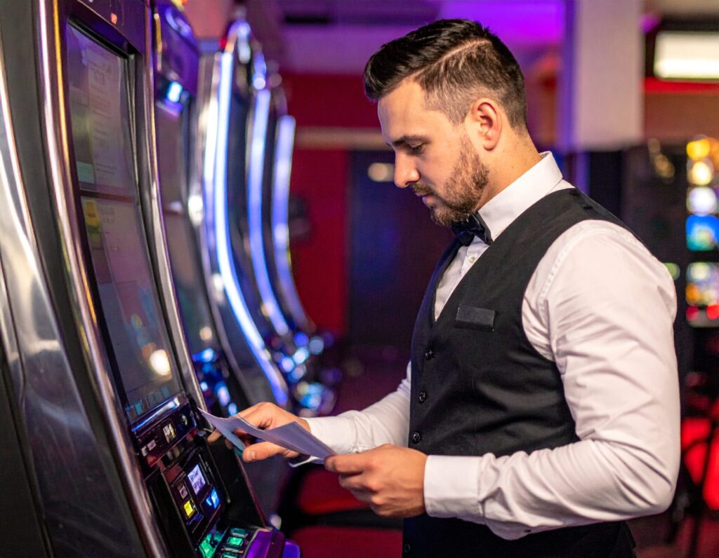 Firefly Australian gaming attendant dressed in bartending uniform checking slot machines