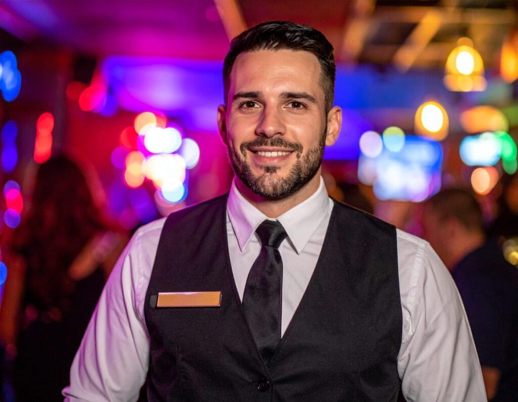 Bartender smiling at the camera inside a casino