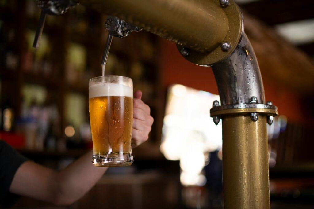 Beer being poured from a tap into a glass