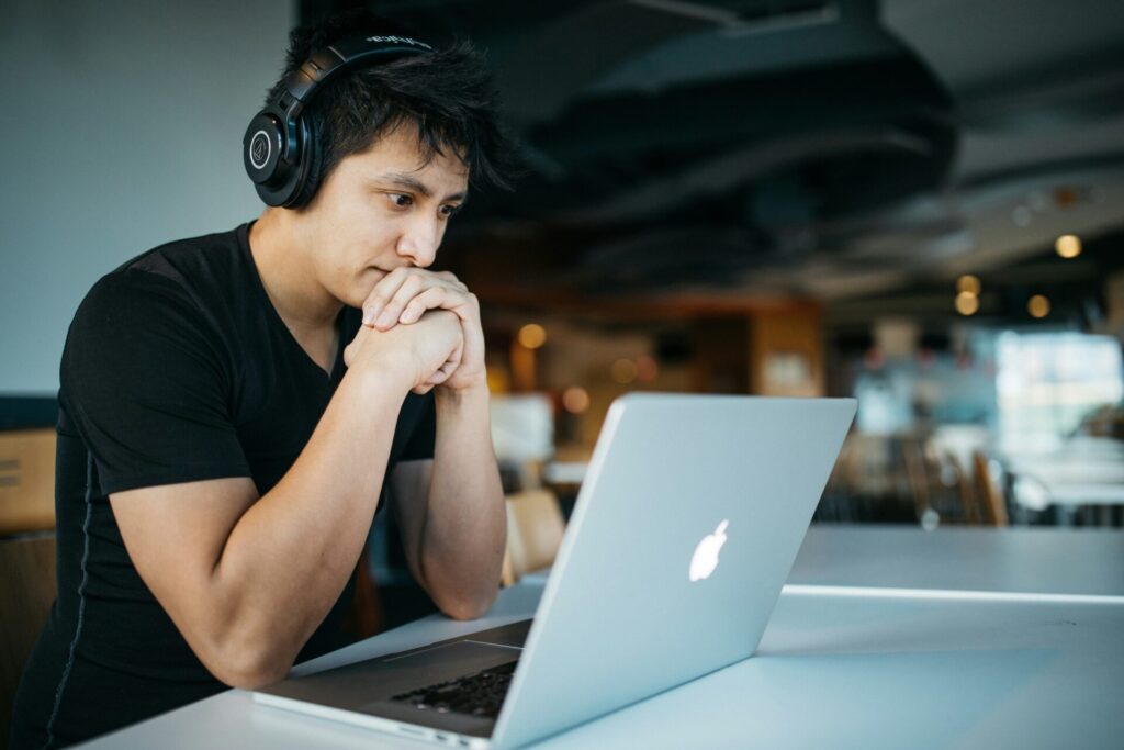 Man working at a laptop at a home office table