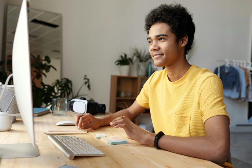 Student attending an online class and taking notes