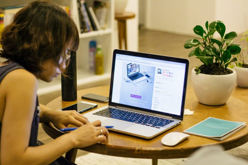 Person working on a laptop at a home office table