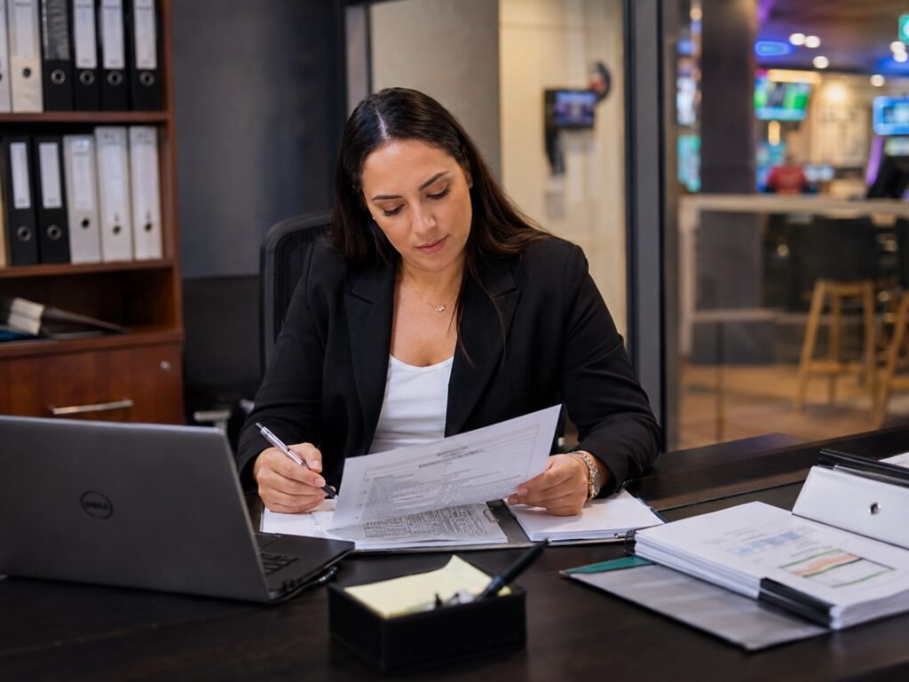 Gaming Compliance Officer Reviewing Paperwork