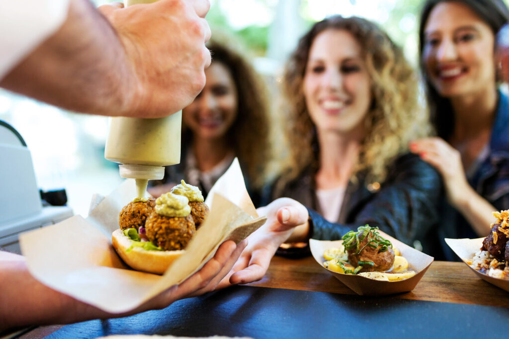Food truck assistant serving food